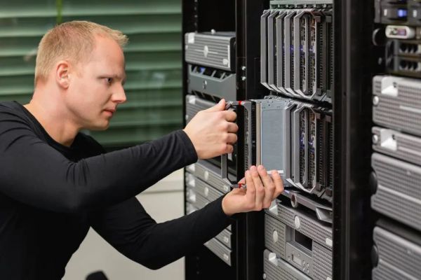 male technical consultant replacing blade server